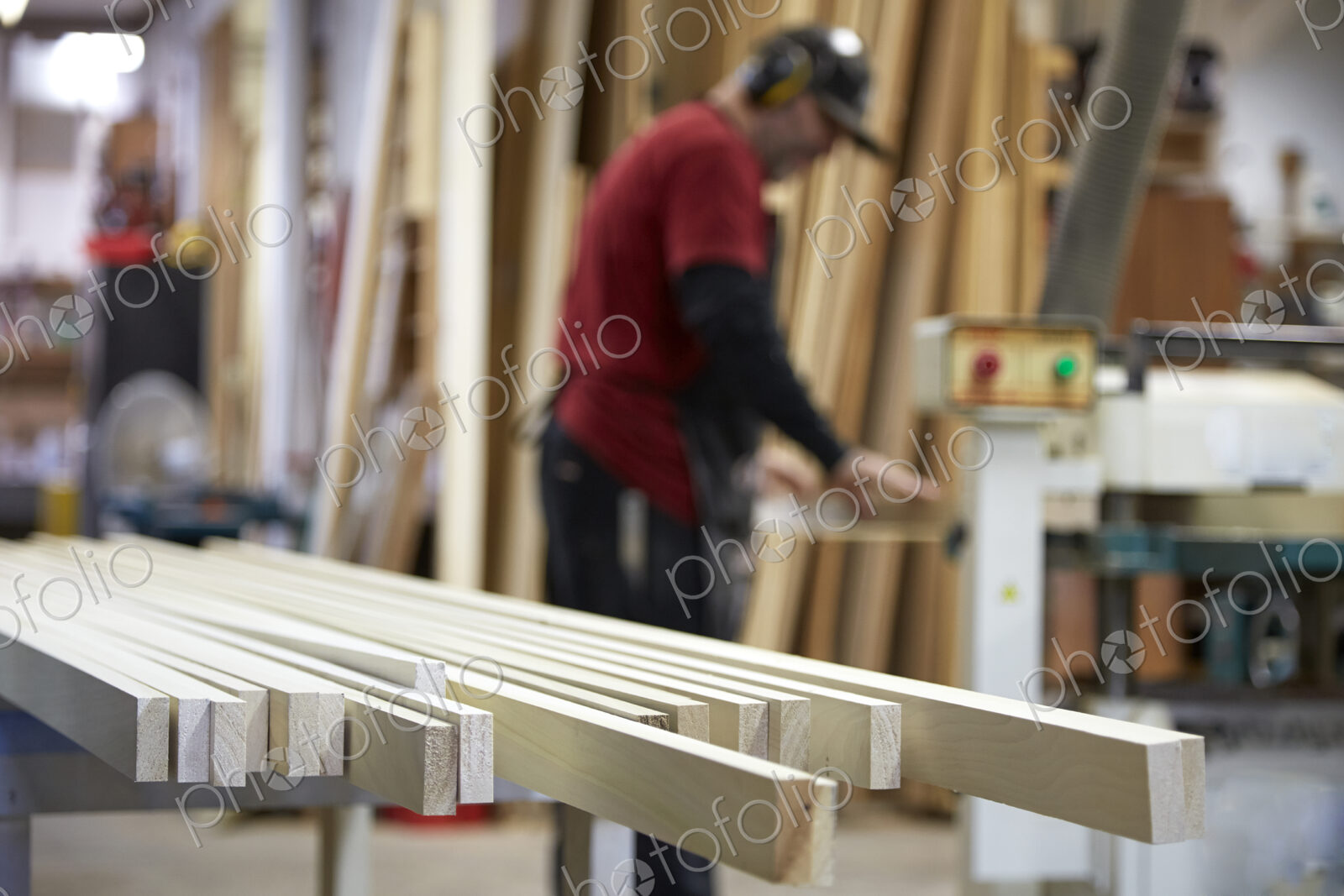 Carpenter using saw in workshop