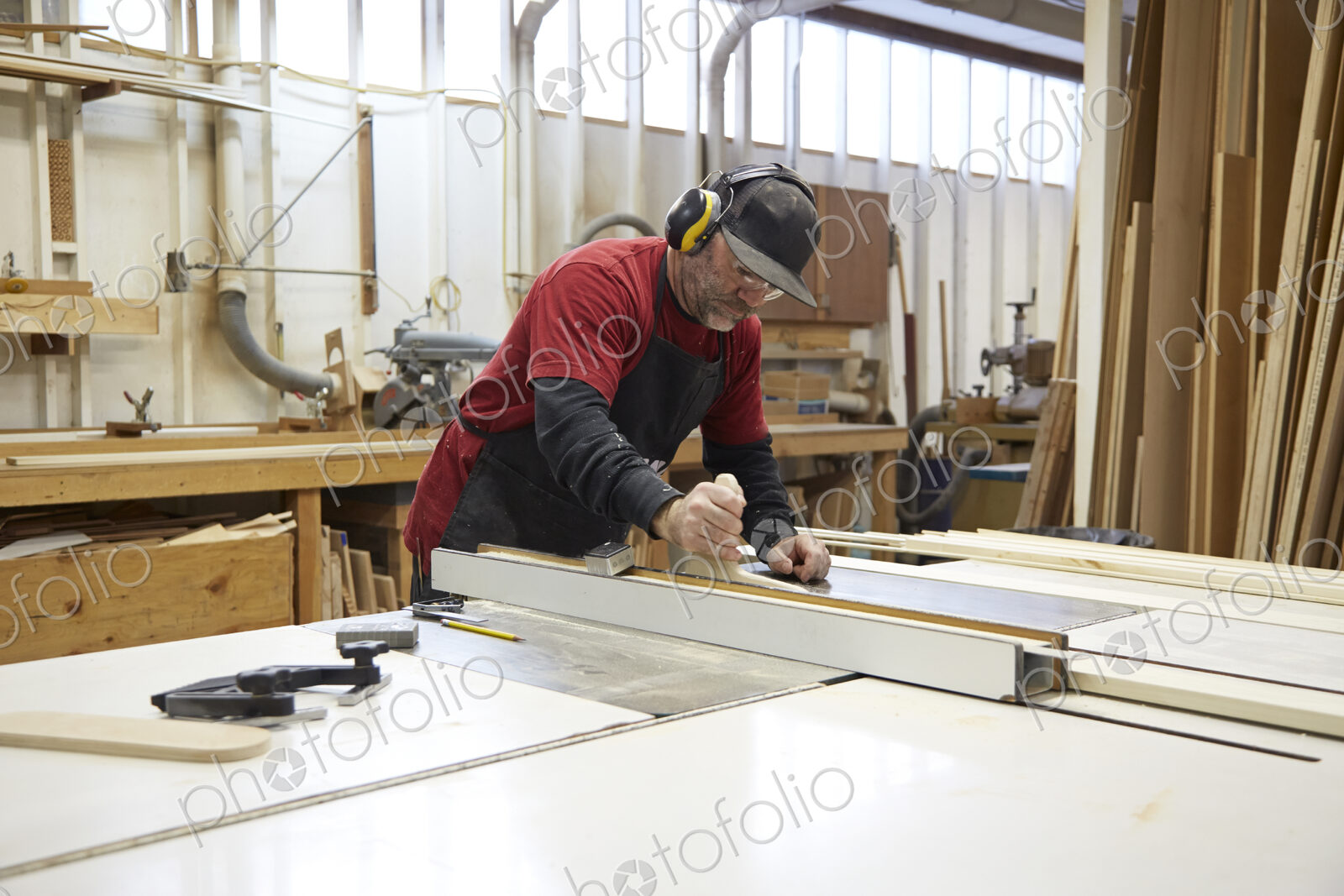 Carpenter using table saw in workshop