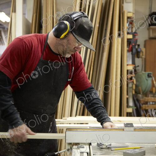 Carpenter using table saw in workshop Carpenter using table saw in workshop