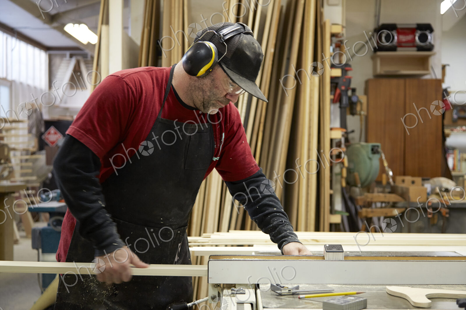 Carpenter using table saw in workshop