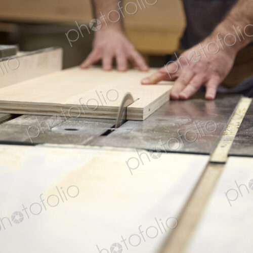 Carpenter using table saw in workshop Carpenter using table saw in workshop