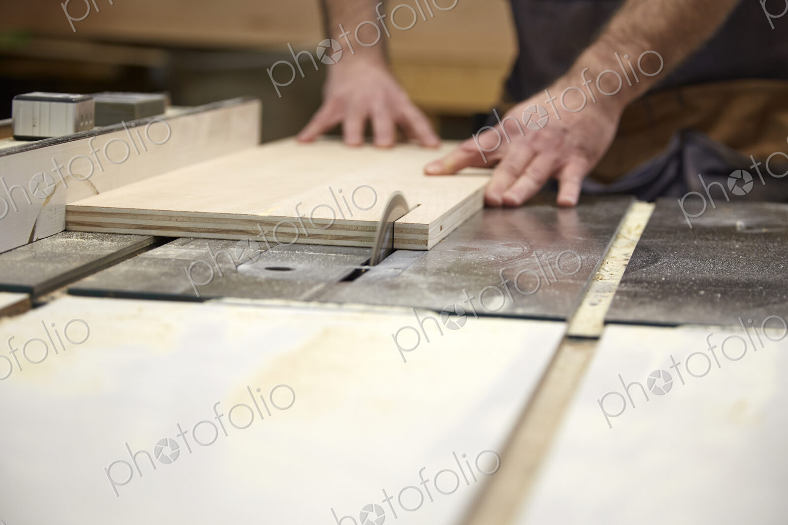 Carpenter using table saw in workshop