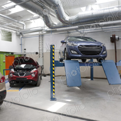 Cars in a large repair workshop or garage. Cars in a large repair workshop or garage.