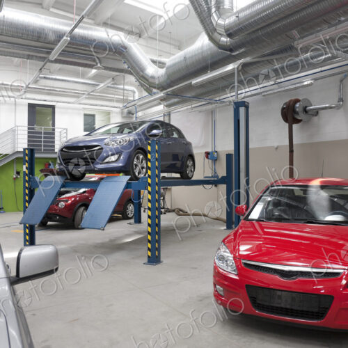 Cars in a large repair workshop or garage. Cars in a large repair workshop or garage.