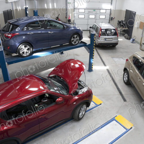 Cars in a large repair workshop or garage. Cars in a large repair workshop or garage.