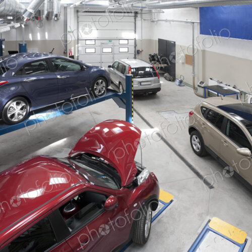 Cars in a large repair workshop or garage. Cars in a large repair workshop or garage.