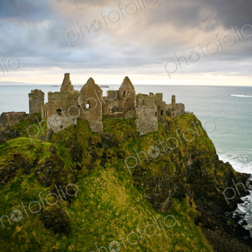 Castle ruins on cliff at ocean Castle ruins on cliff at ocean
