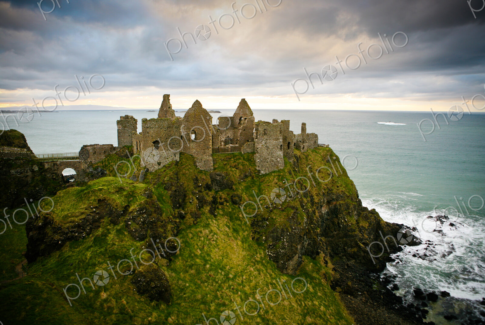 Castle ruins on cliff at ocean