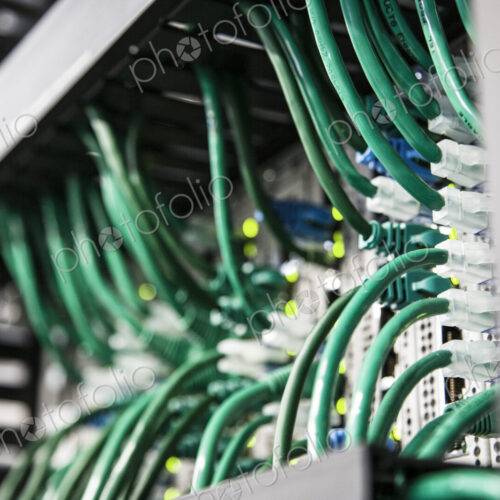 Cat 5 cables hooked to servers in a computer server farm. Cat 5 cables hooked to servers in a computer server farm.