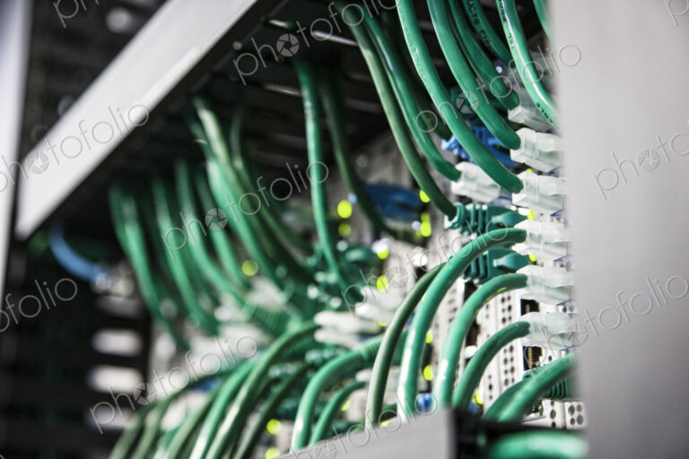 Cat 5 cables hooked to servers in a computer server farm.