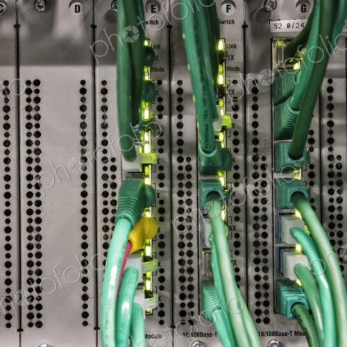 Cat 5 cables plugged into an individual server in a computer server farm. Cat 5 cables plugged into an individual server in a computer server farm.