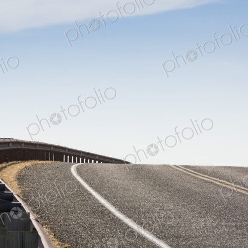 Cattle Pass Road, San Juan Island, a rising tarmac road curving around a bend.