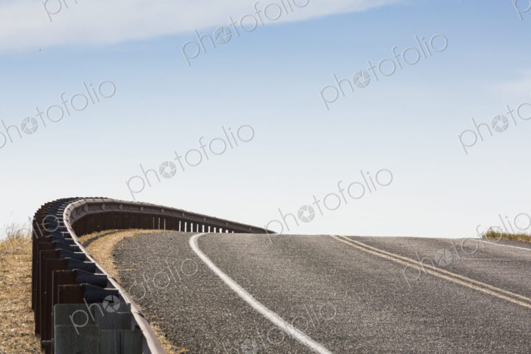 Cattle Pass Road, San Juan Island, a rising tarmac road curving around a bend.