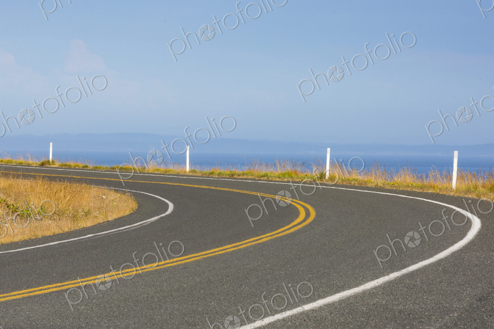 Cattle Pass Road, a curving road along the coast, view over the water.