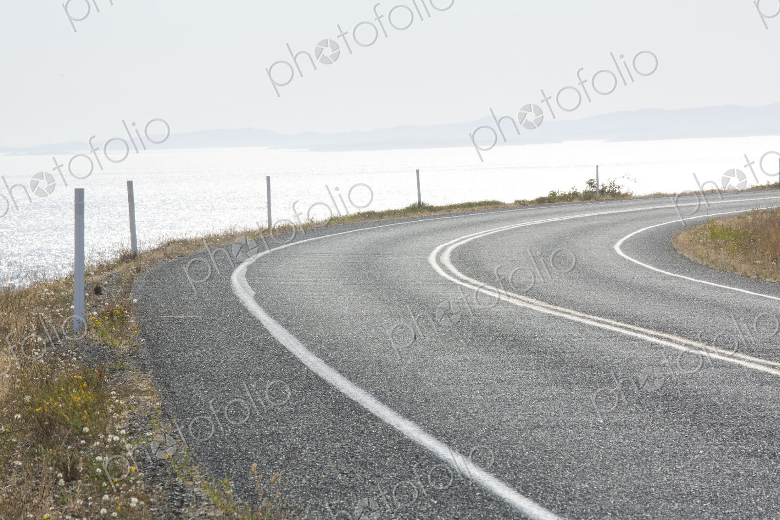 Cattle Pass Road, a curving road along the coast, view over the water.