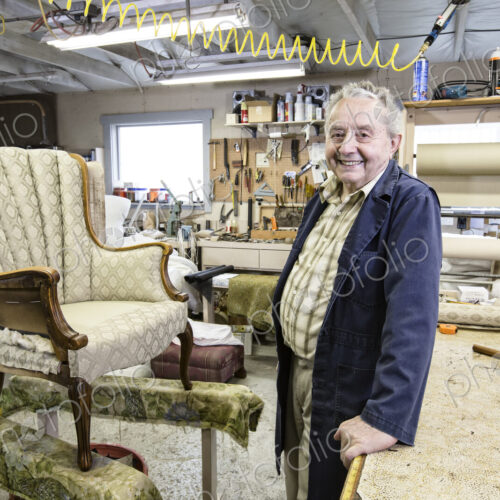 Caucaisan senior male upholsterer working on a chair in his garage shop. Caucaisan senior male upholsterer working on a chair in his garage shop.