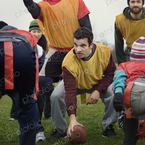 Caucasain man playing quarterback for an non-contact flag football team of friends. Caucasain man playing quarterback for an non-contact flag football team of friends.