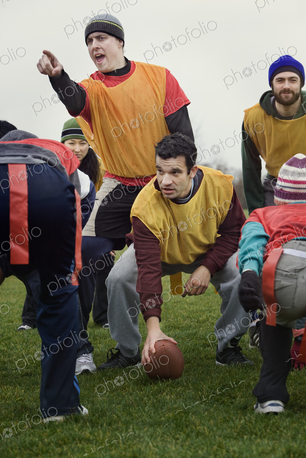 Caucasain man playing quarterback for an non-contact flag football team of friends.