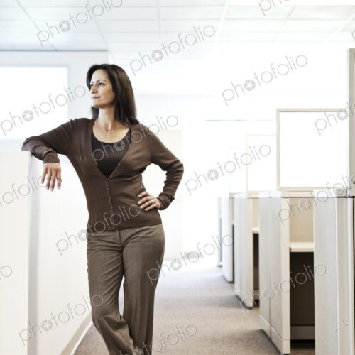 Caucasain woman office worker in cubicle area of office.