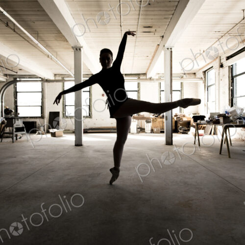 Caucasian ballet dancer performing in loft Caucasian ballet dancer performing in loft