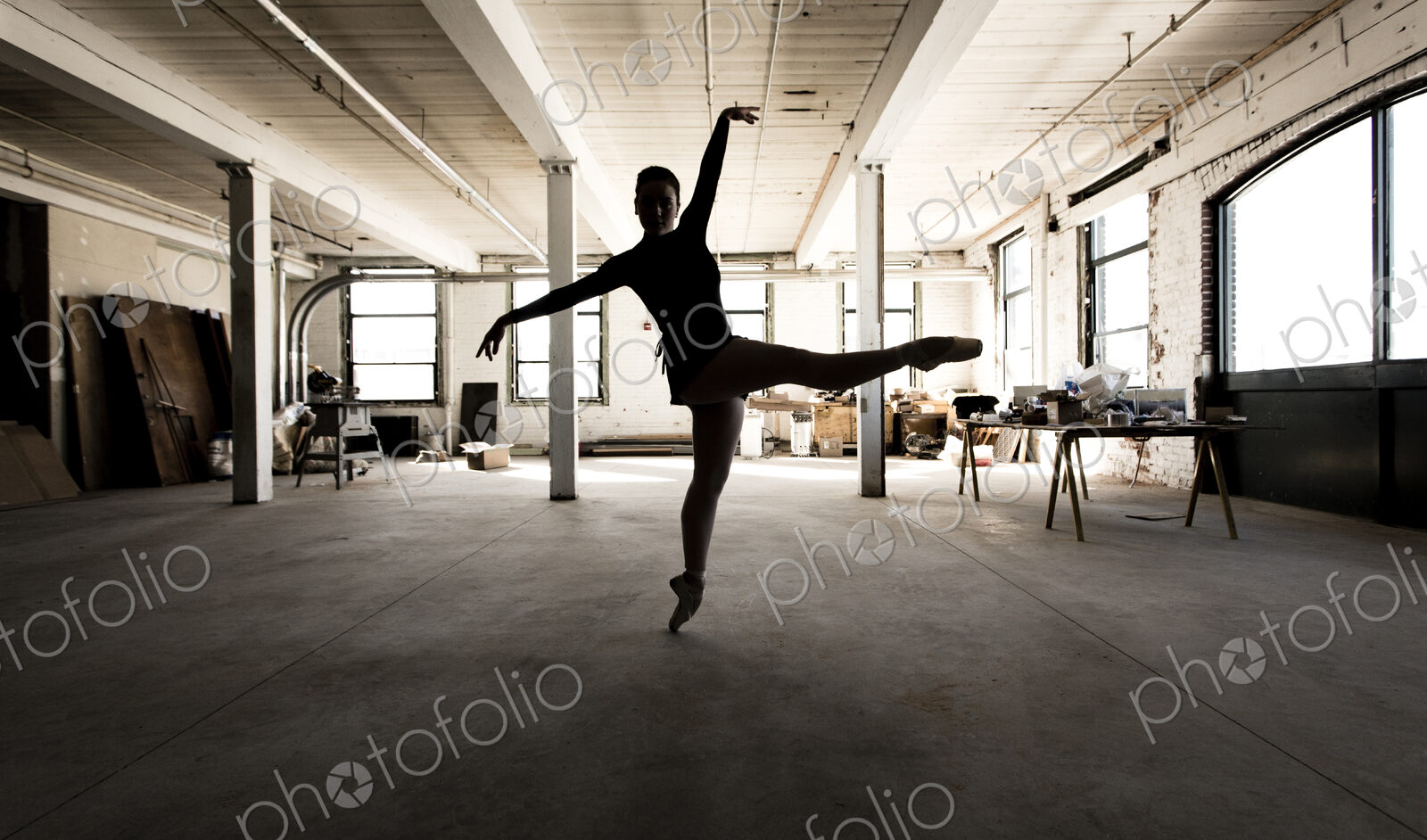 Caucasian ballet dancer performing in loft