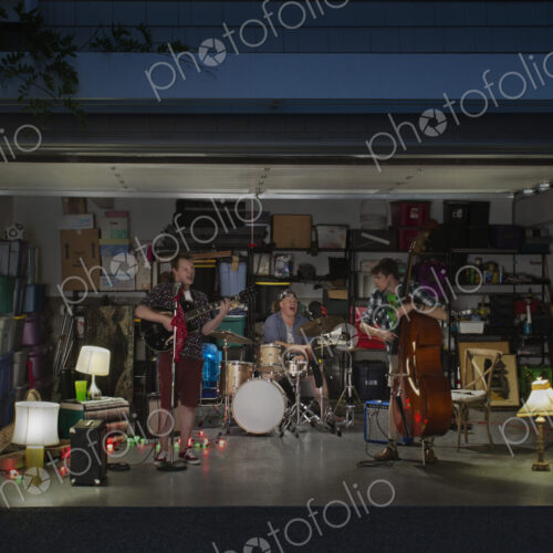 Caucasian band playing in garage Caucasian band playing in garage