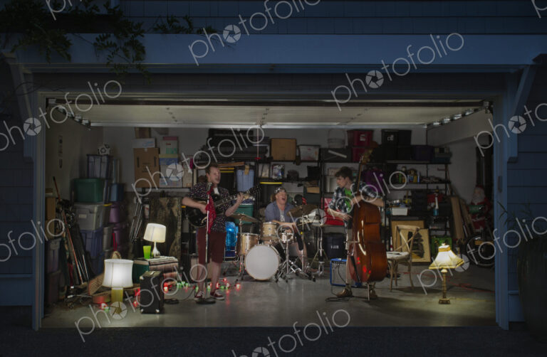 Caucasian band playing in garage