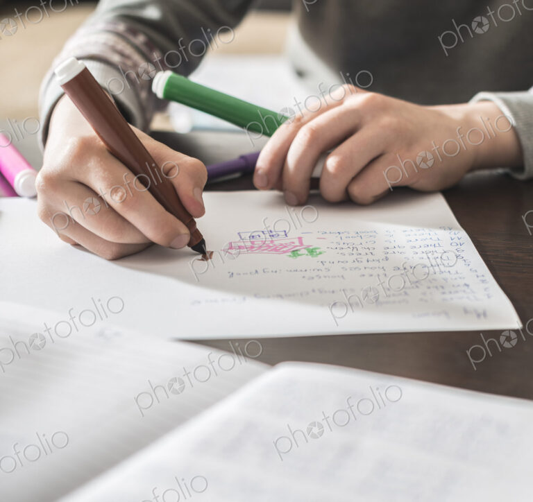 Caucasian boy drawing on paper
