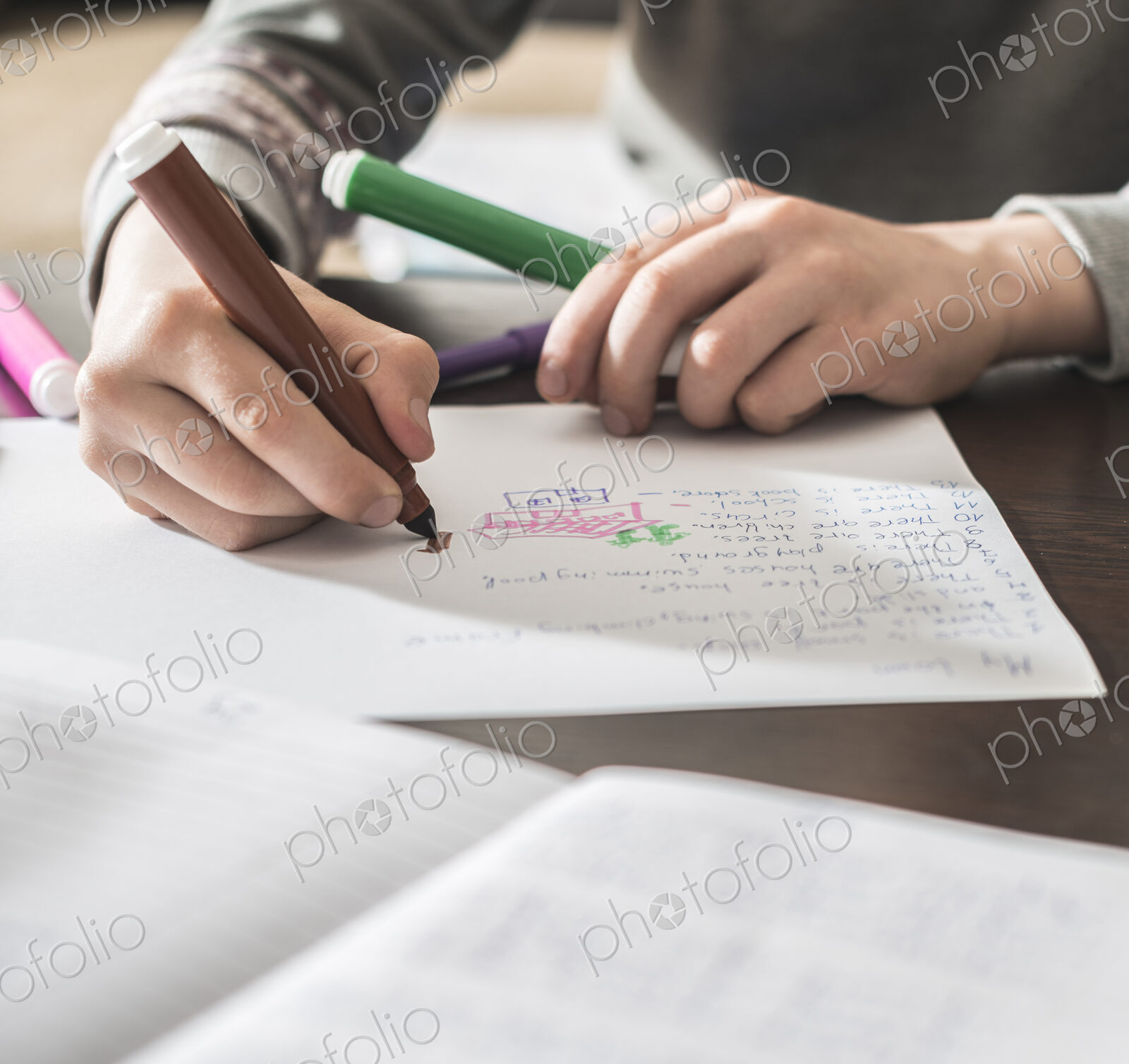 Caucasian boy drawing on paper