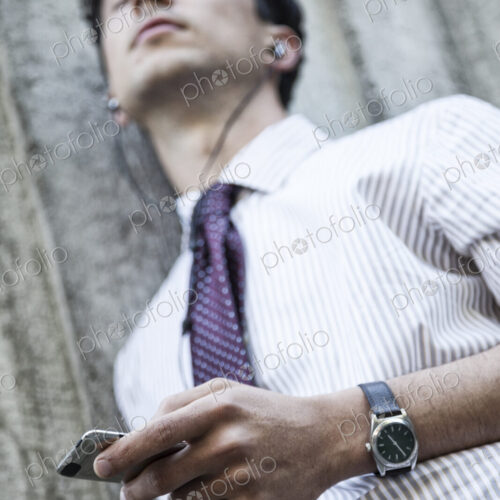 Caucasian businesman listening to music on his phone. Caucasian businesman listening to music on his phone.