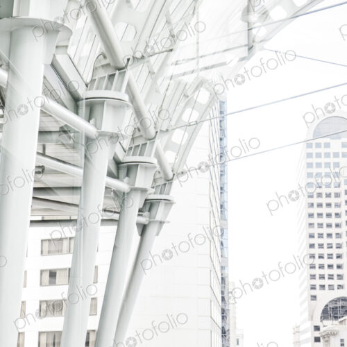 Caucasian business man standing on a balcony overlooking a cityscape.
