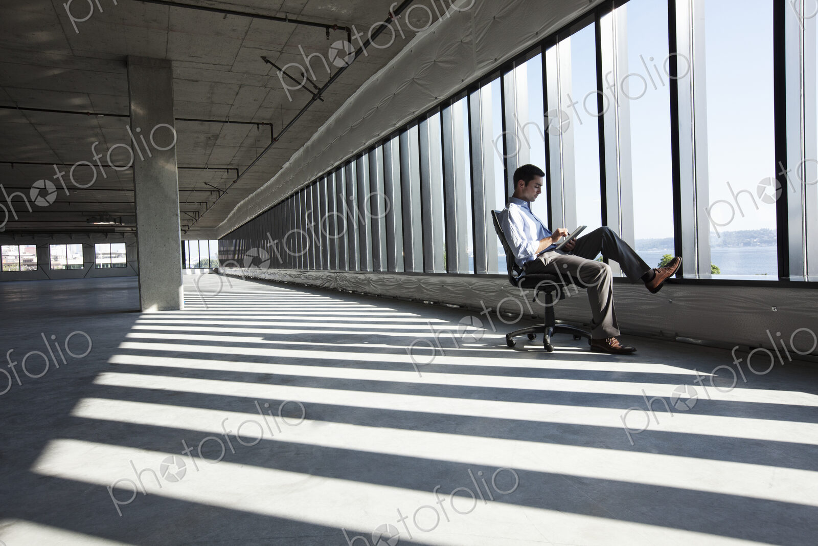 Caucasian business man working on a notebook computer while sitting a new empty raw…