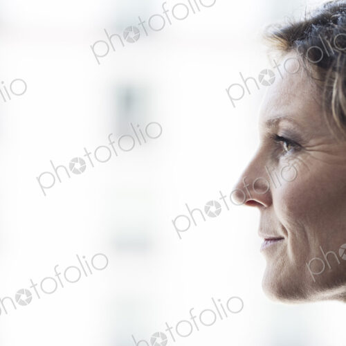 Caucasian business woman looking out the window of a conference centree lobby. Caucasian business woman looking out the window of a conference centree lobby.