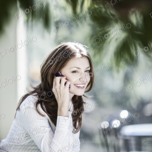 Caucasian business woman on the phone in a lobby waiting area. Caucasian business woman on the phone in a lobby waiting area.