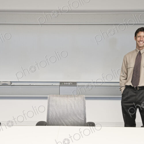 Caucasian businessman in a conference room setting.
