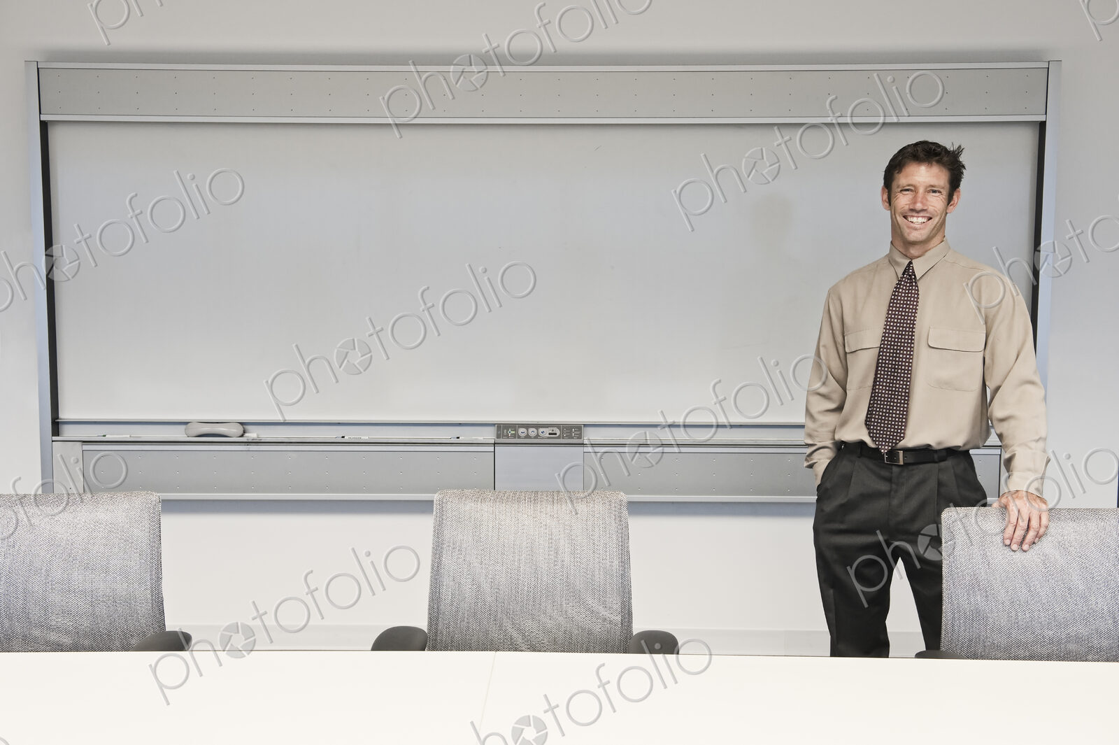 Caucasian businessman in a conference room setting.