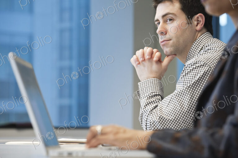 Caucasian businessman in a conference room setting.