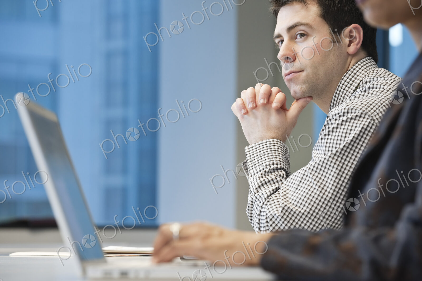 Caucasian businessman in a conference room setting.