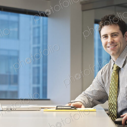 Caucasian businessman in a conference room setting.
