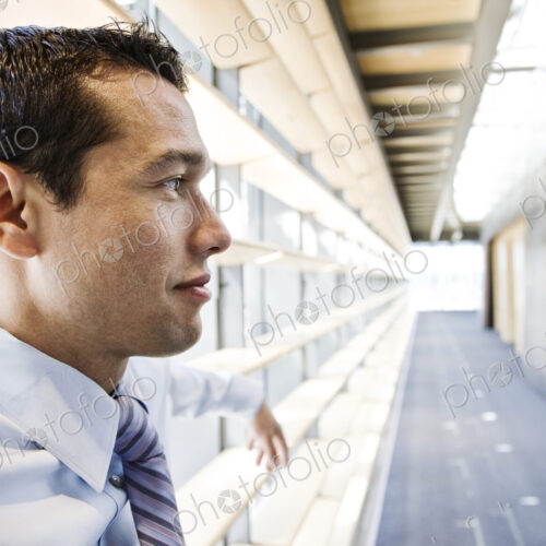 Caucasian businessman in lobby of a large office building.