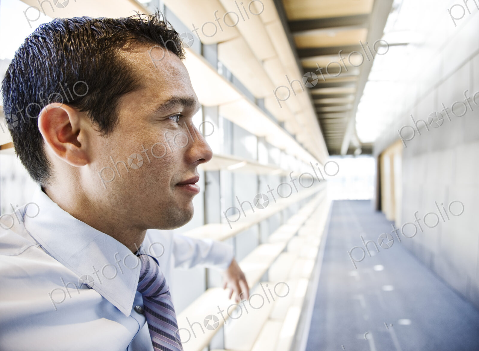 Caucasian businessman in lobby of a large office building.