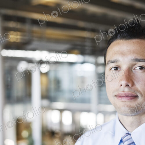 Caucasian businessman in lobby of a large office building.