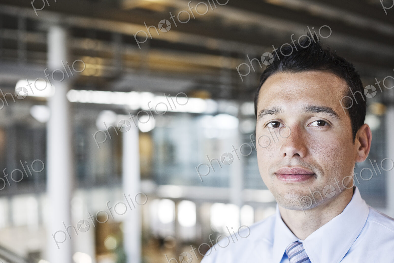 Caucasian businessman in lobby of a large office building.