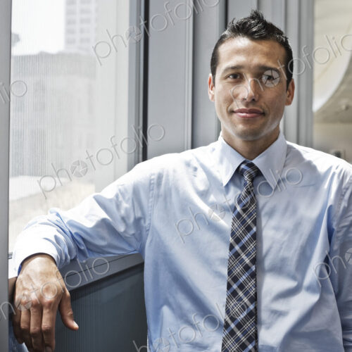 Caucasian businessman in lobby of a large office building.