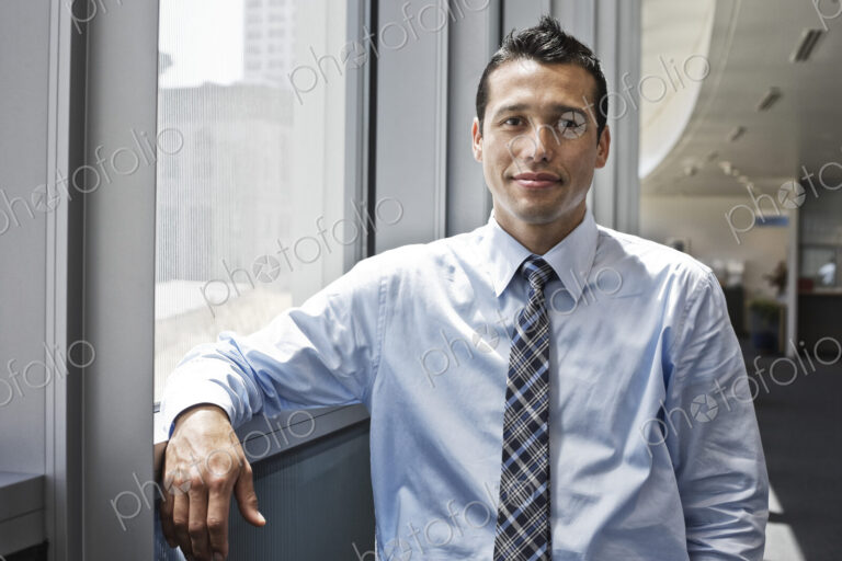 Caucasian businessman in lobby of a large office building.