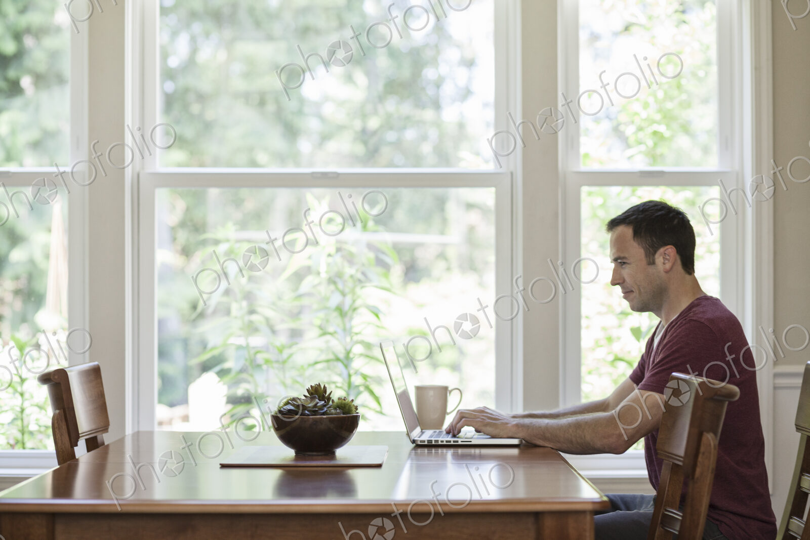 Caucasian businessman working from home using his laptop computer.