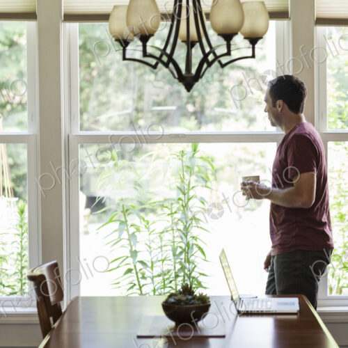 Caucasian businessman working from home using his laptop computer. Caucasian businessman working from home using his laptop computer.