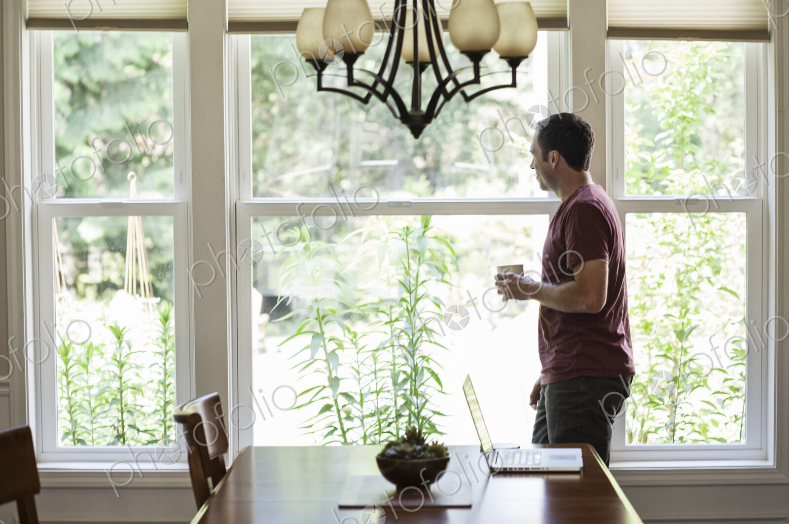 Caucasian businessman working from home using his laptop computer.