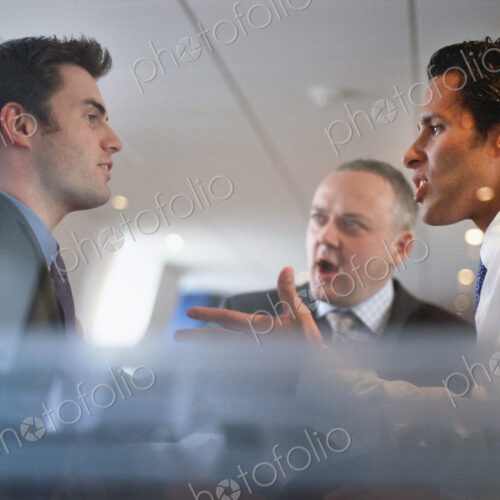 Caucasian businessmen arguing in office