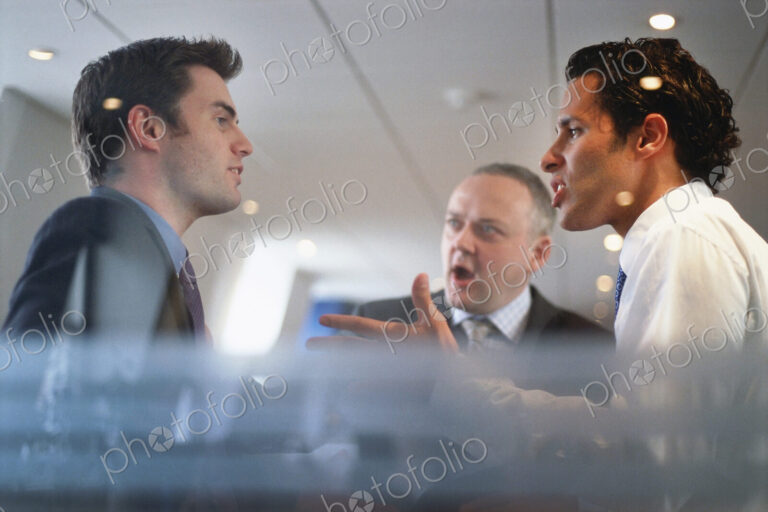 Caucasian businessmen arguing in office
